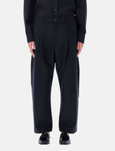 Studio Nicholson cropped wool navy Tuck trousers - | Spazio Pritelli