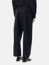 Studio Nicholson cropped wool navy Tuck trousers - | Spazio Pritelli