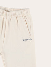 Jogging crema con logo di Sporty & Rich Kids - | Spazio Pritelli