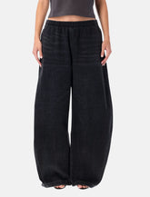 Pantaloni ampi in denim nero elasticizzato di Alexander Wang - | Spazio Pritelli