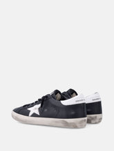 Sneakers Golden Goose Super-Star in pelle nera con stella bianca - | Spazio Pritelli