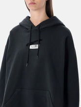 Felpa con cappuccio nera di MM6 Maison Margiela -  | Spazio Pritelli